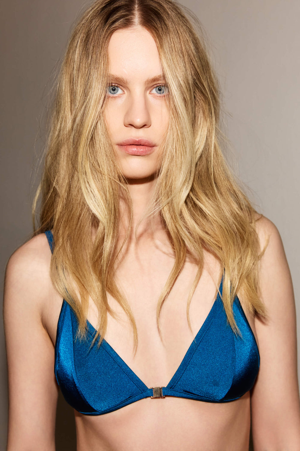 Front view of bikini top in Blue Tropico with gold details and silky shimmer finish by Agda Studios